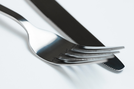 Neat silverware on the white backgroundの写真素材