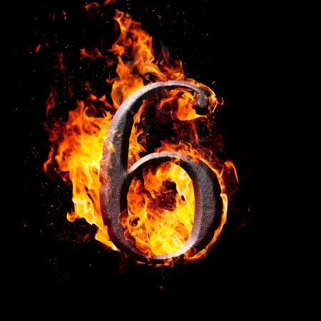 Hot metal burning numbers on black background - number sixの写真素材