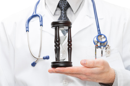 Medical doctor with hourglas in his handの写真素材
