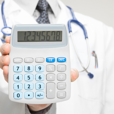 Doctor holding calculator - closeup shot - 1 to 1 ratioの写真素材