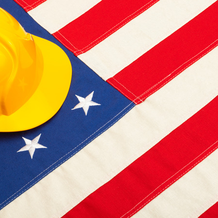 Construction protective helmet over US flag の写真素材