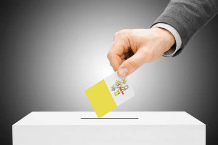 Voting concept - Male inserting flag into ballot box - Vatican Cityの写真素材