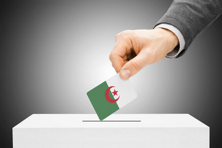 Voting concept - Male inserting flag into ballot box - Algeriaの写真素材