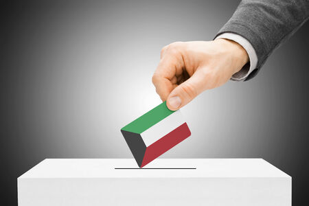 Voting concept - Male inserting flag into ballot box - Kuwaitの写真素材