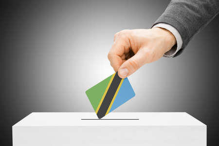 Voting concept - Male inserting flag into ballot box - Tanzaniaの写真素材