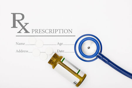 Medical prescription andl pills and stethoscope on tableの写真素材