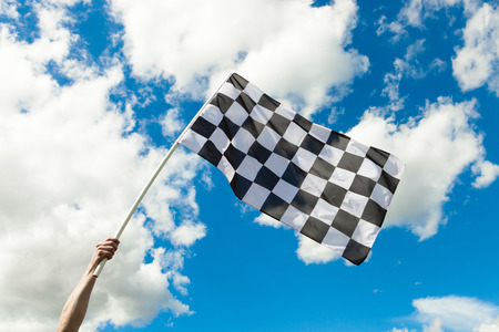 Checkered flag waving in the wind - outdoors shootの写真素材