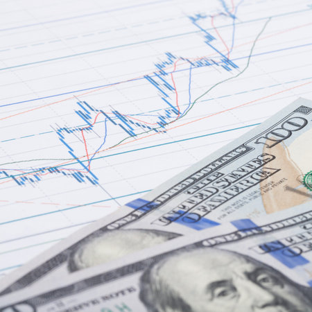 Stock market graph with hundred dollars banknote - studio shot