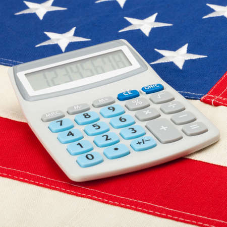 Calculator over big USA flag - accounting conceptの写真素材