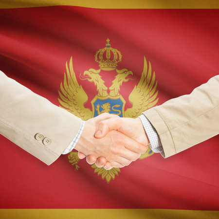 Businessmen shaking hands with flag on background - Montenegroの写真素材