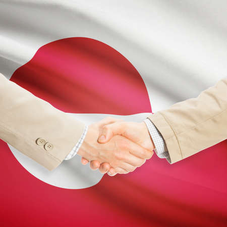 Businessmen shaking hands with flag on background - Greenlandの写真素材