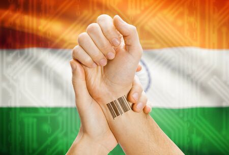 Barcode ID number on wrist of a human and national flag on background - Indiaの写真素材