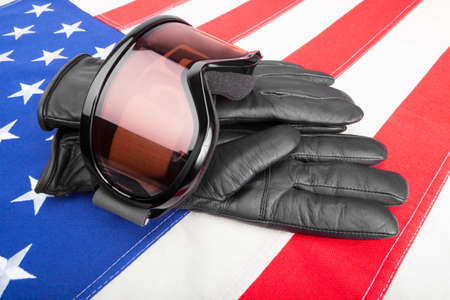 Winter sport goggles and gloves over USA flag - studio shotの写真素材