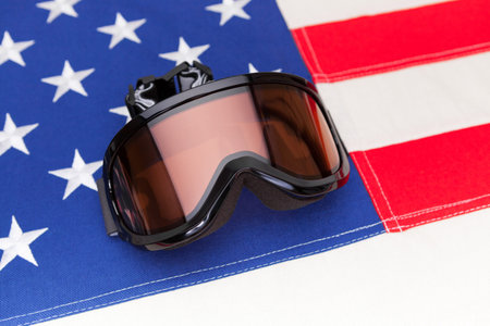 Winter sport goggles over US flag