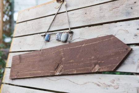 Blank wooden signboard hanging on a rope - close up shot
