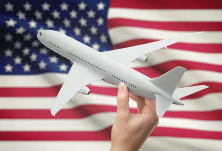 Airplane in hand with national flag on background - United Statesの写真素材