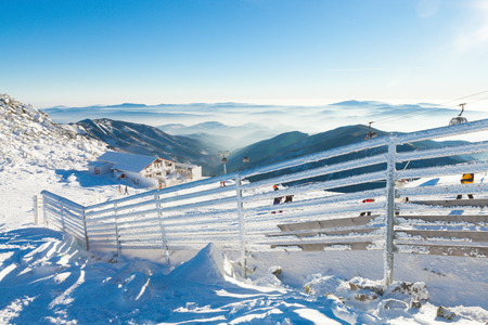 CHOPOK, SLOVAKIA - JANUARY 12, 2017: Fence covered by heavy snow on a sunny day after a heavy blizzard at Chopok, January 12, 2016 in Jasna - Slovakiaのeditorial素材