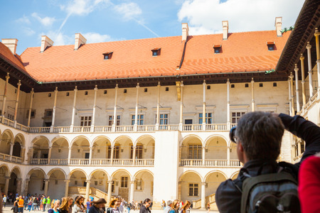 KRAKOW, POLAND - MAY 16, 2015: Photographer taking shots at central part of famous Wawel Royal Castle in Krakow, Poland - May 16, 2015のeditorial素材