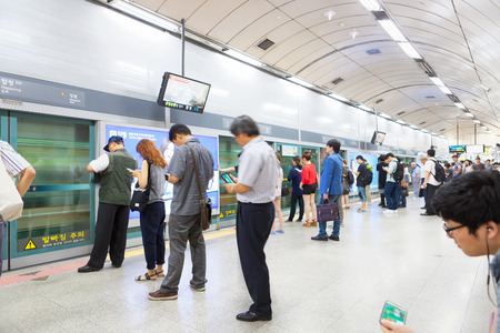 SEOUL, SOUTH KOREA - MARCH 28, 2017: Lots of different people standing in the line on a subway platform and waiting for their train to come - Seoul, South Korea - March 28, 2017のeditorial素材