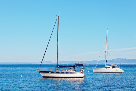 Yatchs moored in the harbor near a small town - Croatia, Brac islandの写真素材