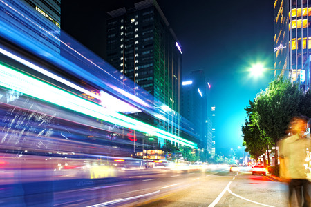 SEOUL, KOREA - AUGUST 10, 2015: Man waiting for a bus at night at Dongdaemun district of Seoul, South Koreaのeditorial素材
