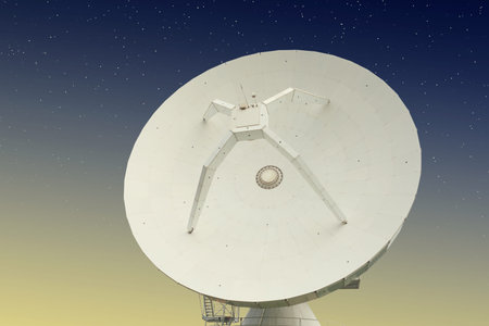 Parabolic antenna at night with stars behind it