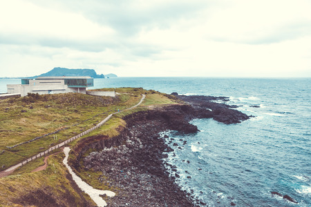 JEJU ISLAND, SOUTH KOREA - AUGUST 19, 2015: Pathiway to famous Seongsan mountain at the shore of volcanic origin Jeju Island - South Koreaのeditorial素材