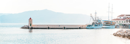 POSTIRA, CROATIA - JULY 13, 2017: Fishing trawler and a boat in the beautiful harbor of town Postira - Croatia, Brac islandのeditorial素材
