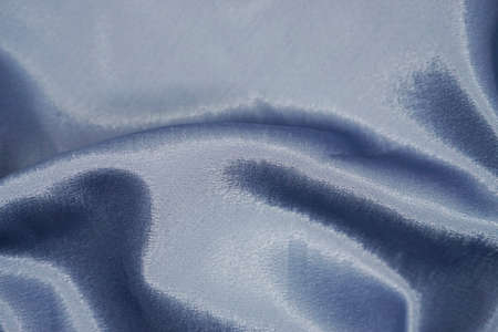 blue satin background with some folds in it, closeup of photoの写真素材