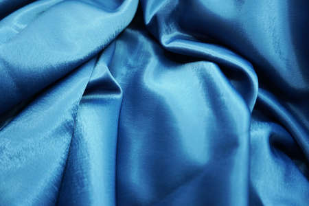 Beautiful blue satin fabric as background, closeup. Space for textの写真素材