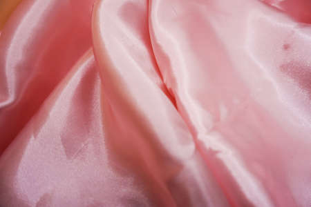 Smooth elegant pink silk or satin texture can use as backgroundの写真素材