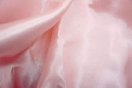 Smooth elegant pink silk or satin texture can use as backgroundの写真素材