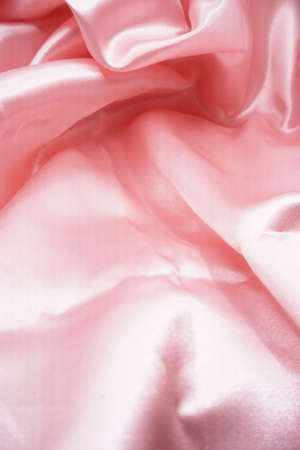 Smooth elegant pink silk or satin texture can use as backgroundの写真素材