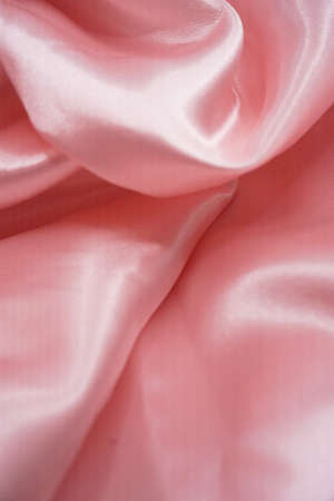 Smooth elegant pink silk or satin texture can use as backgroundの写真素材