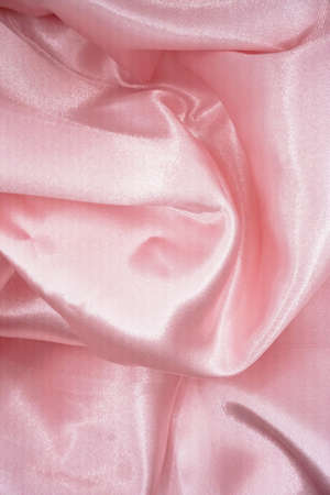 Smooth elegant pink silk or satin texture can use as backgroundの写真素材