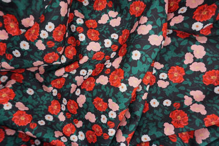 The texture of the fabric is dark green with red flowers. Background, patternの写真素材