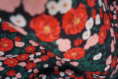 Texture, background, pattern, silk fabric, red flowers on a black background.の写真素材