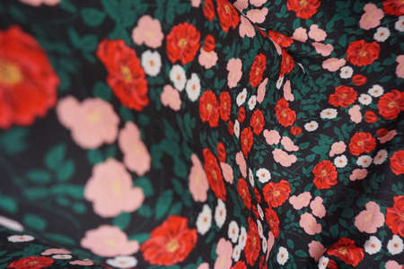 Texture, background, pattern. Silk fabric with a pattern of red and white flowers.の写真素材