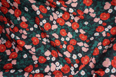 Texture, background, pattern. The fabric is dark green with a floral pattern. Flower print on fabric.の写真素材