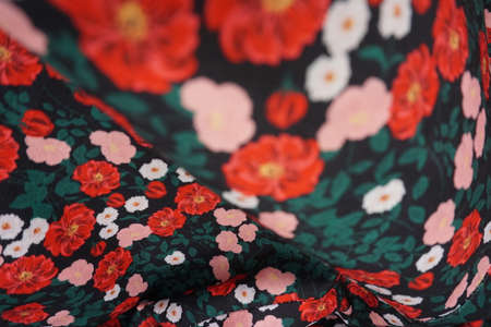 Silk fabric with floral pattern, red flowers on a black backgroundの写真素材