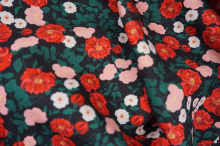 Fabric with a pattern of red and white flowers. Background.の写真素材