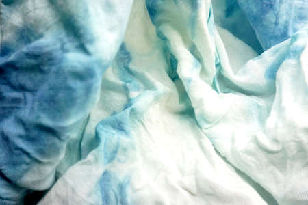 Crumpled blue and white fabric as background, closeup viewの写真素材
