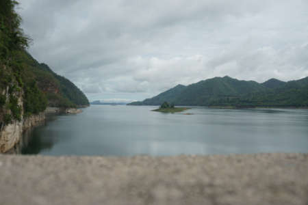 Beautiful view of the dam on the river with cloudy sky.の写真素材