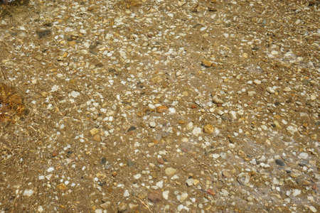 River water with pebbles and stones. Close-up.の写真素材