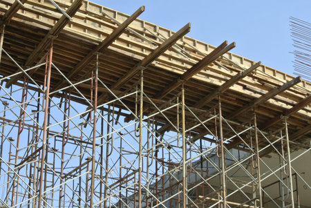 SELANGOR, MALAYSIA ? AUGUST 2014: Timber beam formwork supported by row of scaffolding in...