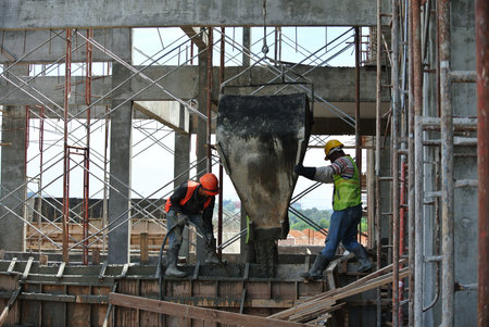 Group of construction workers casting RC wall