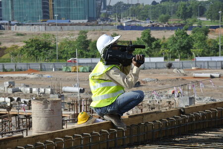 A photographer was recording the construction activity at the construction site.のeditorial素材