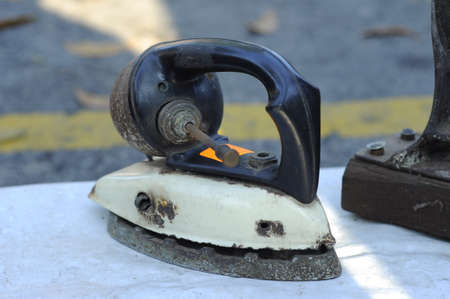 An antique Iron on sale in the famous antiques market in Penang, Malaysia. Antique Market is located at Jalan Tali, Penang.の写真素材