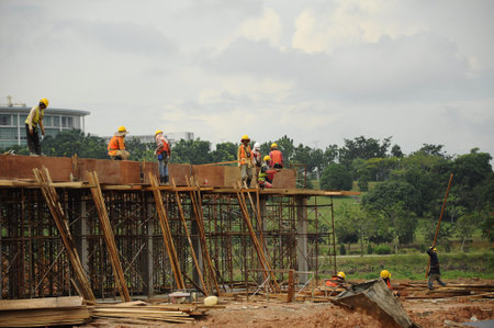 Group of Construction Workers Installing Ground Beam Formworkのeditorial素材