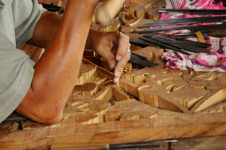 Malaysian traditional woof carving using traditional method by skilled craftsman on November 6, 2014. Craftsman using floral motifs as inspiration to express their creativity.の写真素材
